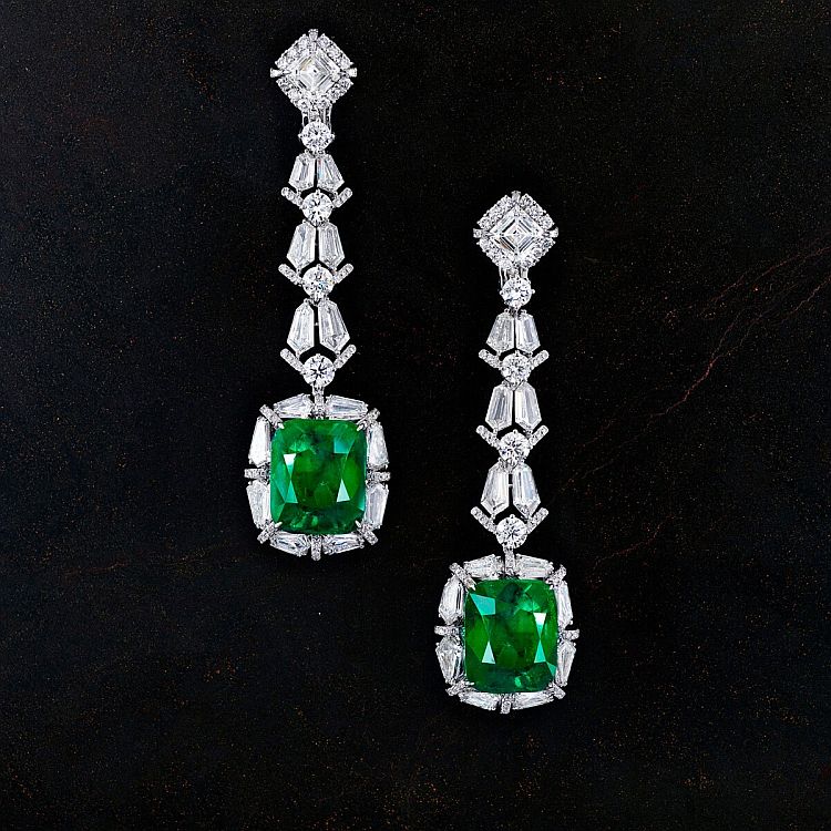 Chatila 18-karat white gold earrings set with two Colombian emeralds of 16.32 carats and 15.30 carats, two Ascher-cut diamonds, and diamonds totaling 18.41carats.