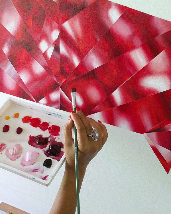 Reena Ahluwalia painting a red diamond.