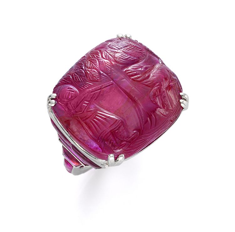 Ruby, diamond and platinum-mounted Art Deco ring with carved cushion-shaped ruby depicting a man shooting a tiger, c. 1925.