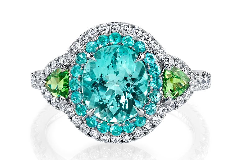 Omi Privé ring in platinum with an oval-shaped cuprian elbaite tourmaline accented by diamonds and Brazilian Paraiba tourmalines. 