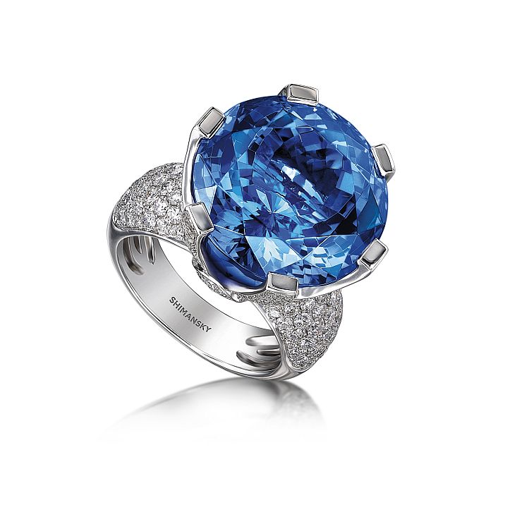 Yair Shimansky ring set with a one-of-a-kind, 27-carat flawless vivid blue tanzanite flanked with 2.30 carats of round brilliant cut diamonds set in 18-karat white gold.