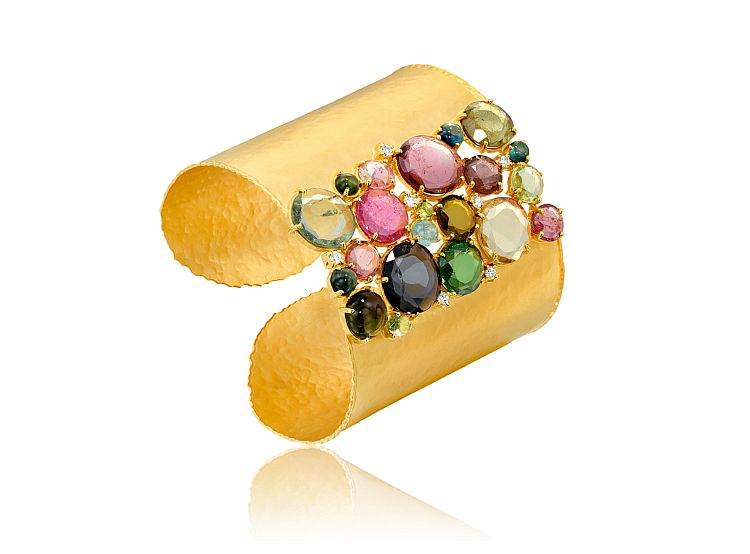 Marika. A mixture of faceted and cabochon colored gems and diamonds decorate this hammered-gold cuff. 
