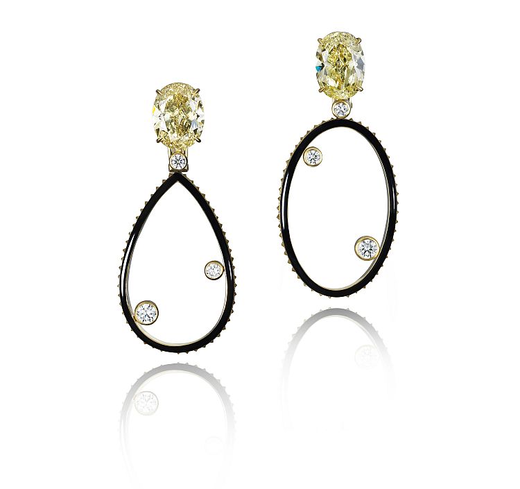 Lily Gabriella for Sotheby's Diamonds. Orbit black enamel asymmetric pendant earrings suspended from two oval-cut fancy-yellow diamonds, weighing 7.06 carats and 7.25 carats with yellow and white pavé-set diamond accents. 