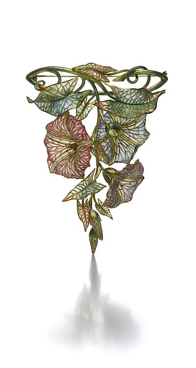 Marcus & Co brooch (ca. 1900). Designed as an articulated morning glory, the petals and leaves applied with various colors of plique-à-jour enamel, the branches applied with translucent green enamel, together with a pale green enamel link chain, with original fitted case with section underneath for the necklace; mounted in 18-karat yellow gold. Image: Siegelson. 