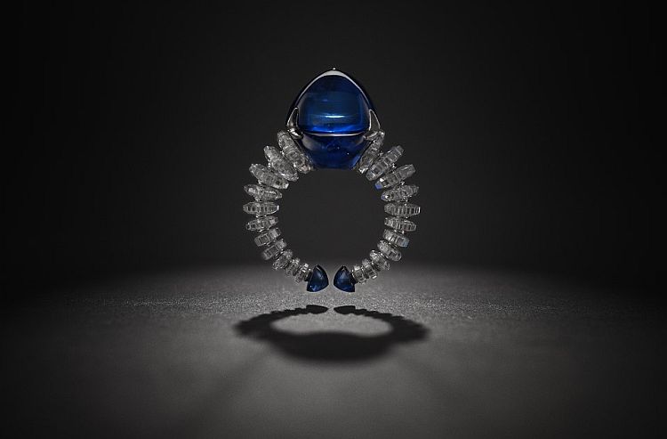 Bhagat platinum ring set with a sugarloaf Burmese sapphire, diamonds and sapphires. 