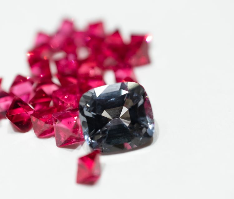 Grey Spinel by B&B Fine Gems against a backdrop of rough hot pink Burmese spinels. Image: Richa Goyal Sikri.