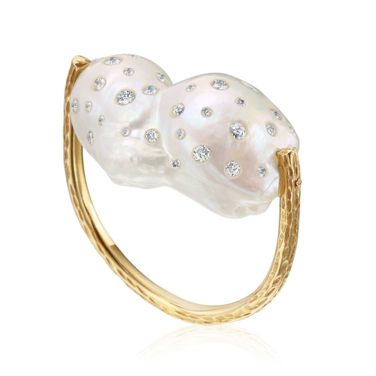 A diamond-inlaid baroque pearl shines in an east-west setting in this 18-karat gold ring by Nina Runsdorf.