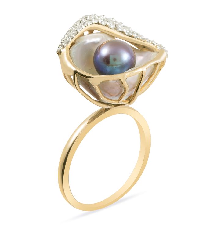 A baroque pearl cups a freshwater peacock pearl in this 18-karat yellow gold ring with diamonds by Zaabel.