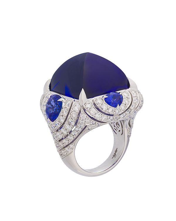 Margot McKinney Tanzanite cocktail ring featuring cabochon tanzanite of 63.25 carats enhanced with diamonds and tanzanites crafted in 18 karat white gold. 