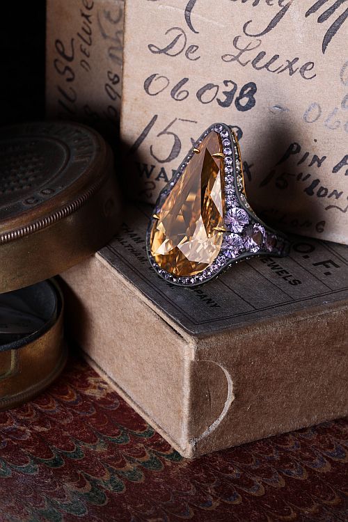 David Michael 18-karat yellow gold and blackened silver sterling ring set with a 12.05-carat fancy brownish yellow diamond, 95 graduated single cut white diamonds and violet sapphires.