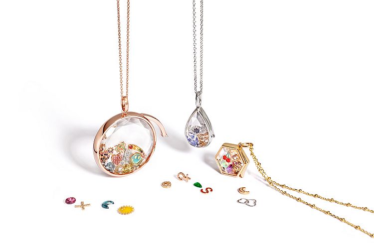 Loquet customizable crystal locket in 18-karat gold and sapphire, which the wearer can fill with individually sold precious charms.