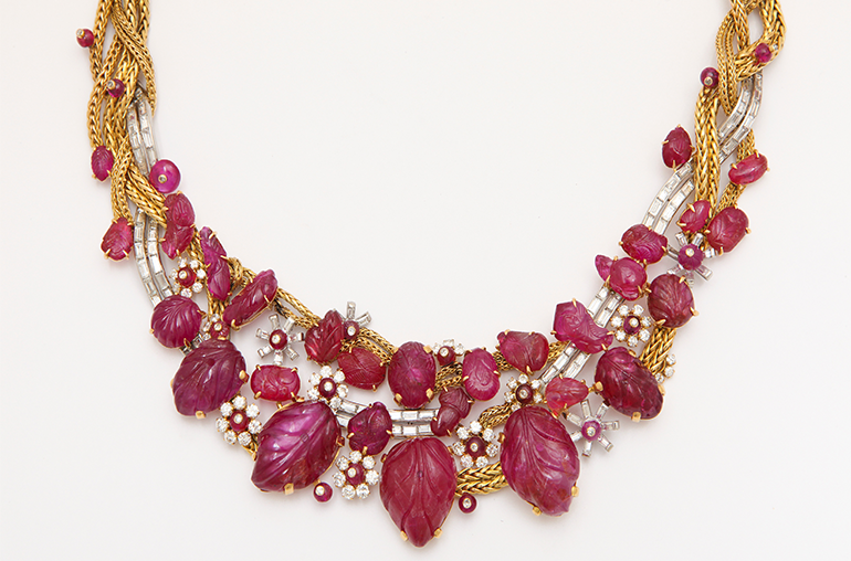 Ruby and diamond 18-karat yellow gold and platinum-mounted necklace by Marchak Paris, c. 1945-1950, set with numerous carved Burmese rubies interspersed with ruby bead and diamond clusters and accented by an undulating diamond ribbon with a double row of baguette diamonds