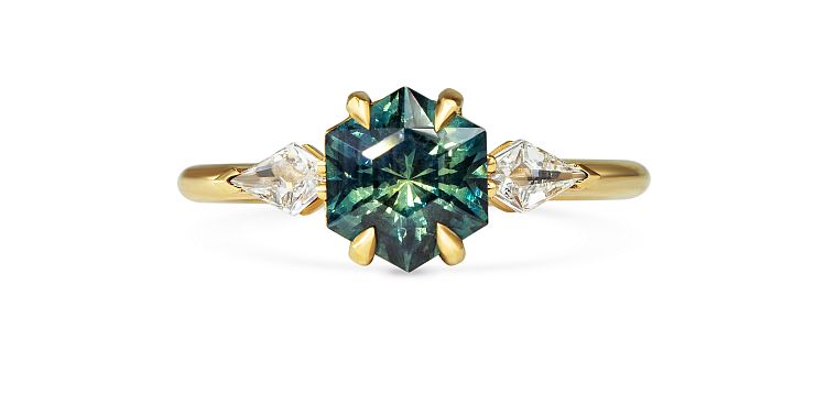 Michelle Oh Danja ring in 18-karat yellow gold with a hexagon-cut teal sapphire and two kite-shaped white diamonds.