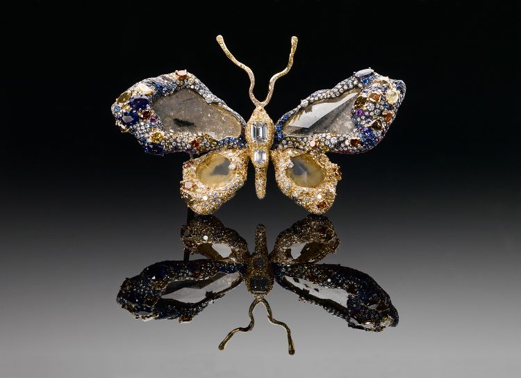 The intricate design and craftsmanship of the Royal Butterﬂy Brooch highlights 2,318 gems totaling 77 carats. Four large faceted diamond slices stacked atop a pavé layer of faceted diamonds form the centerpieces of the wings. The Royal Butterﬂy is set with sapphires and diamonds (and rubies and tsavorite garnets on the reverse side). Gift of the designer Cindy Cha. Photo: Donald E. Hurlbert, Smithsonian Institution. 