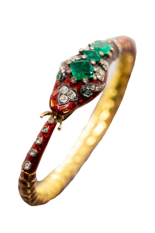 Fred Leighton antique Victorian snake bracelet in 18-karat gold with red enamel, Colombian emeralds, and old mine and rose-cut diamonds, circa 1860s. 