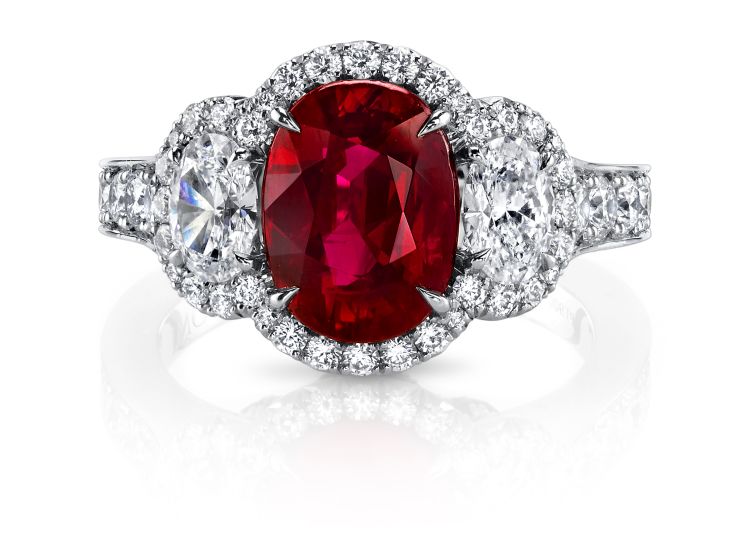 Omi Privé platinum ring featuring an oval, 3.03-carat Burmese ruby accented by 0.35 carats of round rubies, 0.73 carats of oval-cut diamonds, and 0.90 carats of round brilliant diamonds.