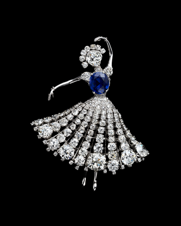 A ballerina clip, by Van Cleef & Arpels New York, c. 1951, with a large mixed-cut sapphire bodice and a swirling skirt of diamonds.