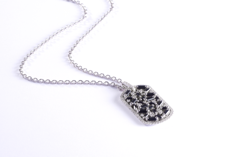 Suzanne Kalan dog tag necklace in 18-karat gold with black sapphire baguettes and white diamonds. Photo: Suzanne Kalan.