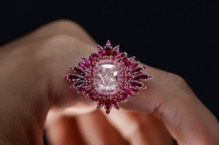 Maggi Simpkins ring centering a cushion-cut, 2.43-carat fancy-pink diamond, surrounded by rubies and pink sapphires.