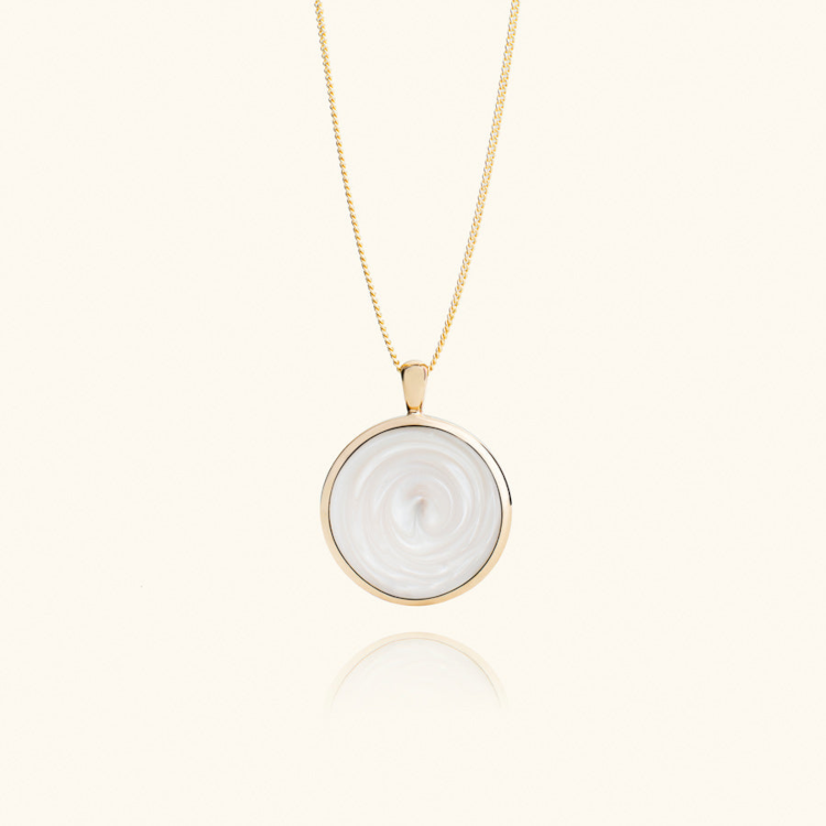 Their necklace is made with an artificial crystal stone that contains a chip for scanning. Photo: Evermée.  