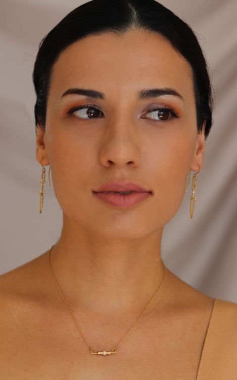 Model wearing the Kitty Ears necklace and Cocoon earrings in 18-karat yellow gold with diamonds. Photo: Chandally.