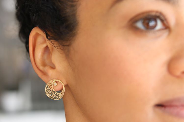Model wearing the Moonshine earrings in 18-karat yellow gold with diamonds. Photo: Chandally. 