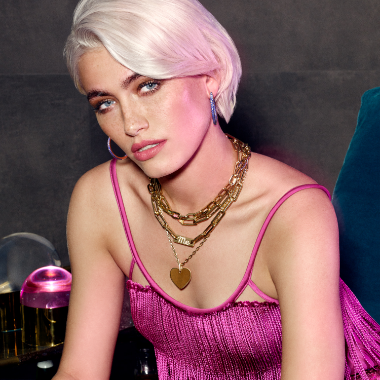 A model wearing Disco hoops in 14-karat gold, sapphire and diamond, and a selection of gold necklaces. (Robinson Pelham)