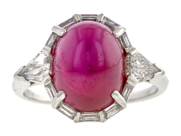 Vintage platinum ring with an oval cabochon star ruby weighing 9.30 carats, flanked by 0.80 carats of kite-shaped diamonds and 10 baguette-cut diamonds totalling 0.25 carats. (Doyle & Doyle)