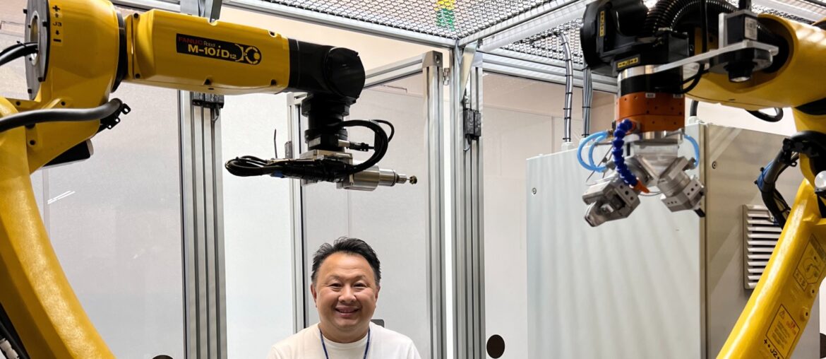 Christian Tse stands beside his robotic polishing system. (Christian Tse)