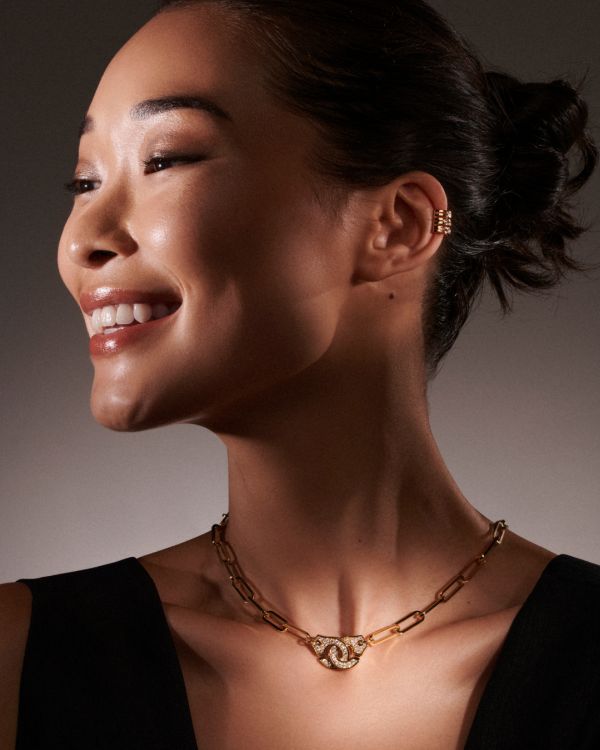 Model wearing the Pulse ear clip and Menottes collier, both in 18-karat yellow gold with diamonds. (Dinh Van)