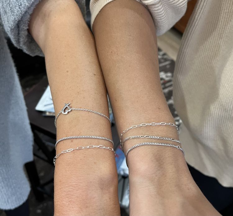 Sather’s sterling silver bracelets worn by friends. (Sather's)