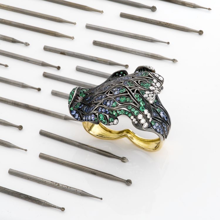 Two-finger Hokusaï wave ring set with Ceylon sapphires, emeralds, and diamonds, in 18-karat Fairmined yellow gold and recycled blackened silver. (Maison Alix Dumas)