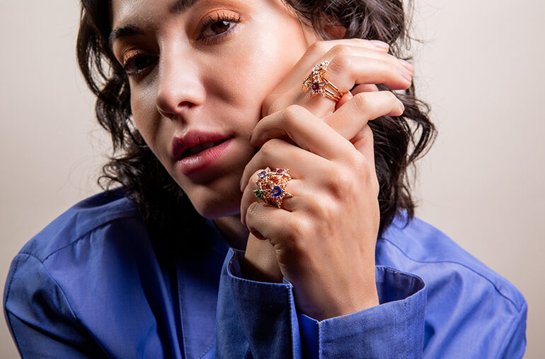 Selim Mouzannar Model wearing rings from the Istanbul collection in 18-karat gold with various colored gemstones.