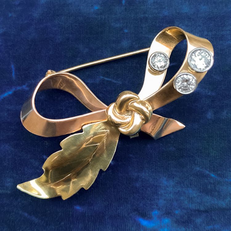 Doyle & Doyle’s retro brooch in 14 karat rose and green gold, bezel set with three round brilliant cut diamonds. (Doyle & Doyle)