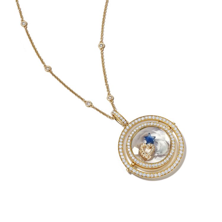 Loquet Saturn Revolving locket in 18-karat gold with moon, heart, and blue-sapphire star charms. (Loquet)
