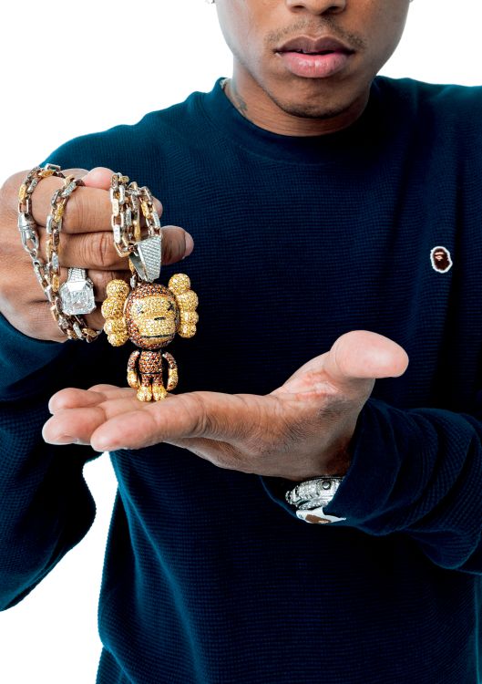 Pharrell Williams with Baby Milo x KAWS pendant in yellow and white gold, yellow, brown and white diamonds, and rubies, designed by Jacob & Co., 2007. (P.M. Ken)