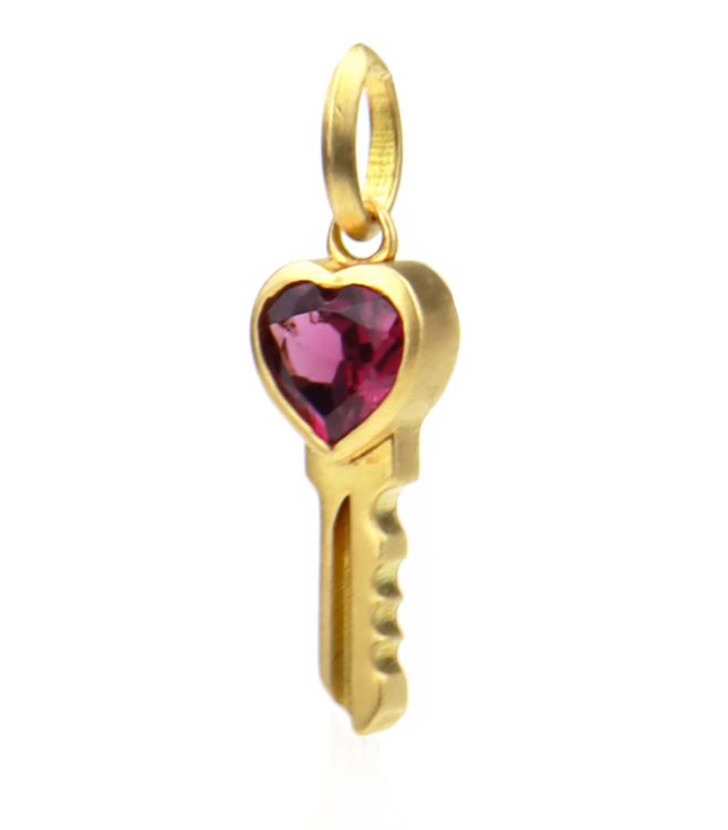 Meili Heart Key Emblem in 18-karat gold with garnet. (Meili)